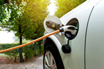 Charging an electric car with the power cable supply plugged in.Flare light effect